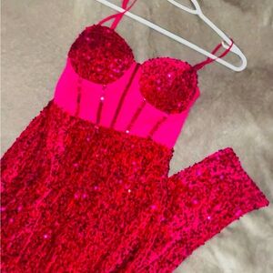 Pink sequin dress with a corset top and a slit perfect for a special event